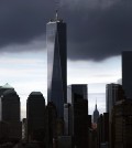 Sailboats pass below the 1 World Trade Center, Saturday, Aug. 23, 2014, in New York. Next month will mark the 13th anniversary of the attacks of Sept. 11, 2001. (AP Photo/John Minchillo)