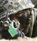 A South Korean marine aims his machine gun during the U.S.-South Korea joint landing exercises called Ssangyong as part of the Foal Eagle military exercises in Pohang, South Korea, Monday, March 31, 2014.  South Korea says North Korea has announced plans to conduct live-fire drills near the rivals' disputed western sea boundary.(AP Photo/Ahn Young-joon)