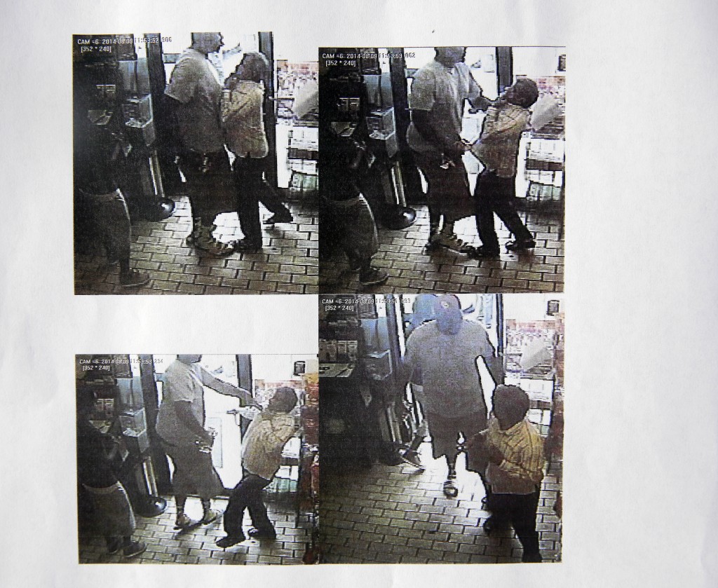 These images provided by the Ferguson Police Department show security camera footage from a convenience store in Ferguson, Mo., on Aug. 9, 2014, the day that Michael Brown was fatally shot by a police officer. A report released Friday, Aug. 15, 2014, by Ferguson Police Chief Thomas Jackson says the footage shows a confrontation between Brown and an employee at the store. The report says that Brown and his friend, Dorian Johnson, stole a box of cigars from the store shortly before Brown's death. (AP Photo/Ferguson Police Department)