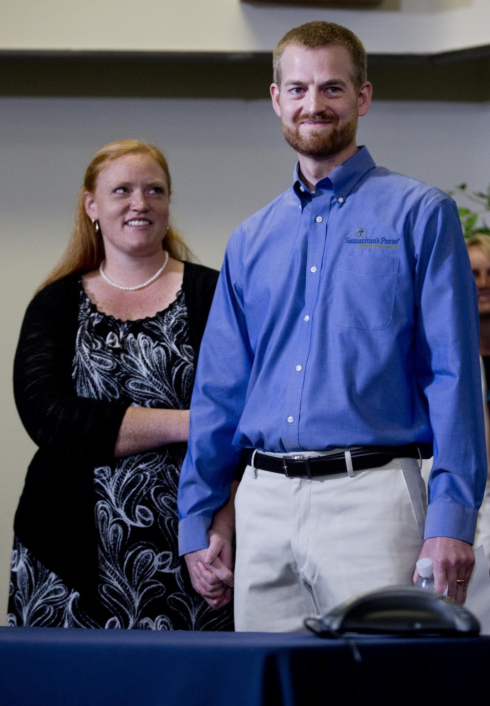 Ebola victim Dr. Kent Brantly stands with his wife, Amber, during a news conference after being released from Emory University Hospital, Thursday, Aug. 21, 2014, in Atlanta. Another American aid worker, Nancy Writebol, who was also infected with the Ebola virus, was released from the hospital Tuesday. (AP Photo/John Bazemore)