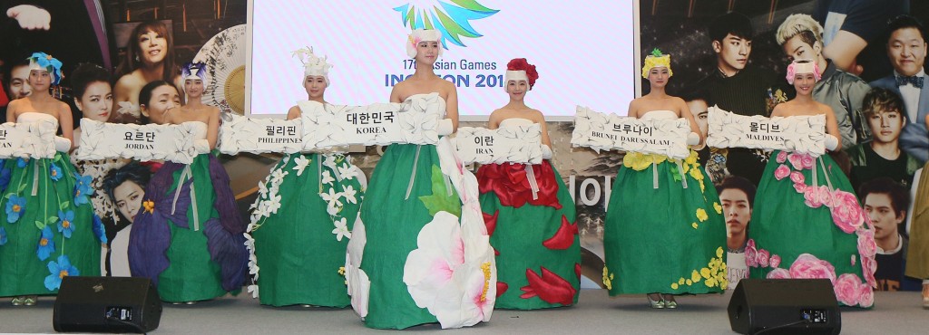 Models pose in modernized traditional clothes, made for the opening ceremony of the 2014 Incheon Asian Games, during a news conference at the National Museum of Modern and Contemporary Art in central Seoul Wednesday. (Yonhap)