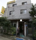 A chef and owner Oh Keum-il of Daegyo, the dog meat restaurant, stands outside of her restaurant in Seoul, South Korea. (AP)