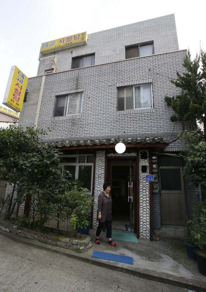 A chef and owner Oh Keum-il of Daegyo, the dog meat restaurant, stands outside of her restaurant in Seoul, South Korea. (AP)