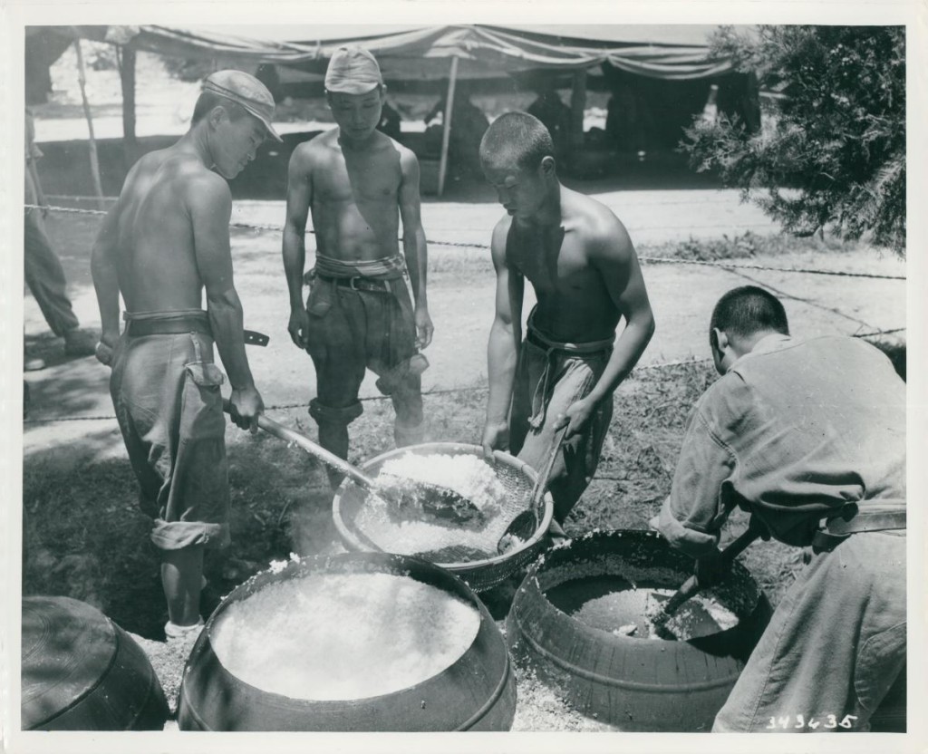 The caption on the back reads: "South Korean troops prepare chow on the front lines. Rice Its the main part of the meal. 14 July 1950." (Official Department of Defense photo)