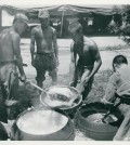 The caption on the back reads: "South Korean troops prepare chow on the front lines. Rice Its the main part of the meal. 14 July 1950." (Official Department of Defense photo)