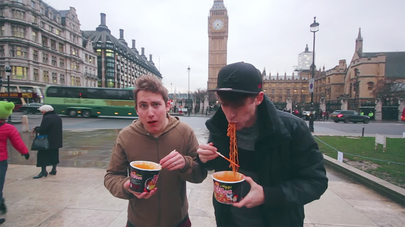 Ollie Kendal and Josh Carrott eat spicy Korean noodles in a video featuring Londoners' reactions to the food. (YouTube screen capture)