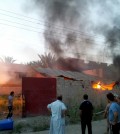 Civilians inspect a burned house after a bombing in Fallujah, 40 miles (65 kilometers) west of Baghdad, Iraq, Monday, Sept. 15, 2014. (AP Photo)