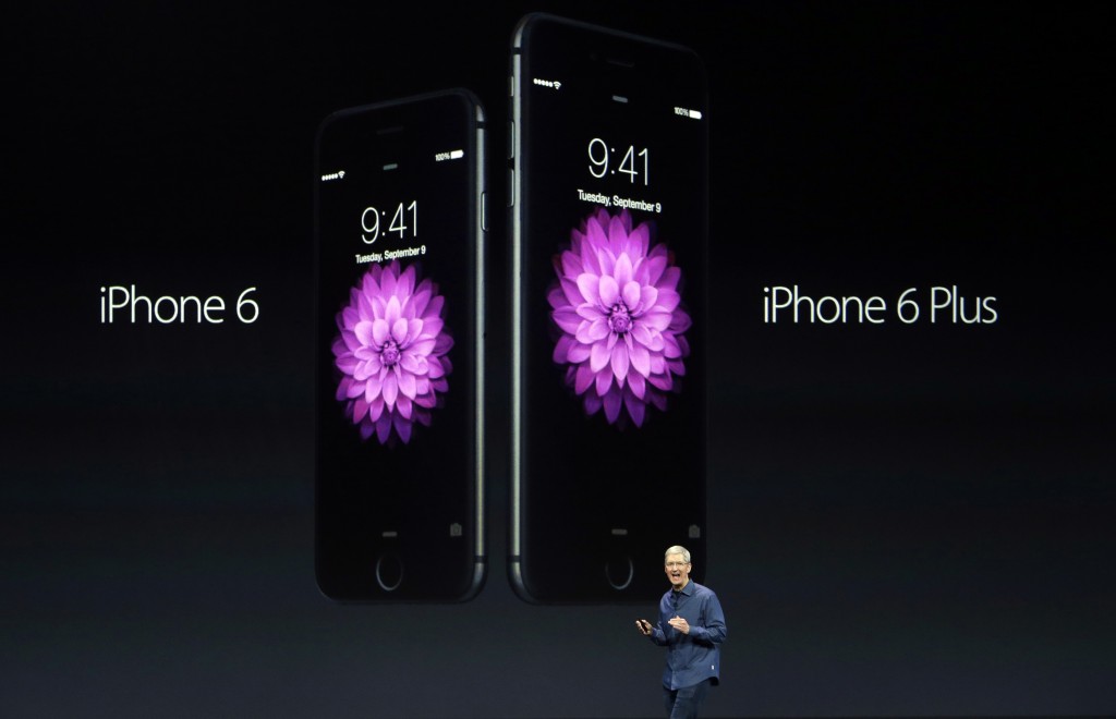 Apple CEO Tim Cook introduces the new iPhone 6 and iPhone 6 Plus on Tuesday, Sept. 9, 2014, in Cupertino, Calif. (AP Photo/Marcio Jose Sanchez)