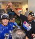 Los Angeles Dodgers' A.J. Ellis, left, is doused with champagne by Hyun-Jin Ryu, of South Korea after they defeated the San Francisco Giants 9-1 and clinching the National League West Division title in a baseball game, Wednesday, Sept. 24, 2014, in Los Angeles. (AP Photo/Mark J. Terrill)