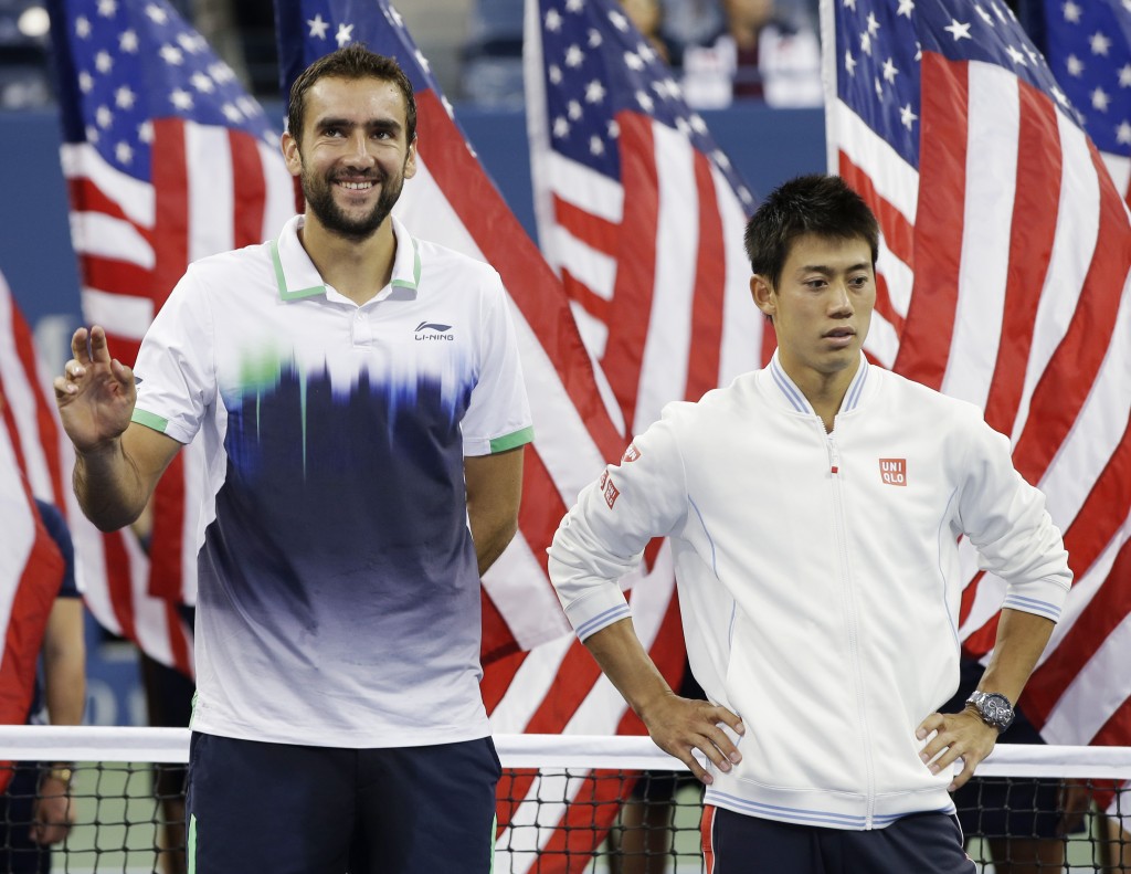 Marin Cilic, of Croatia, left, and Kei Nishikori, of Japan, stand for the trophy ceremony after Cilic defeated Nishikori in the championship match of the 2014 U.S. Open tennis tournament, Monday, Sept. 8, 2014, in New York. (AP Photo/Darron Cummings)