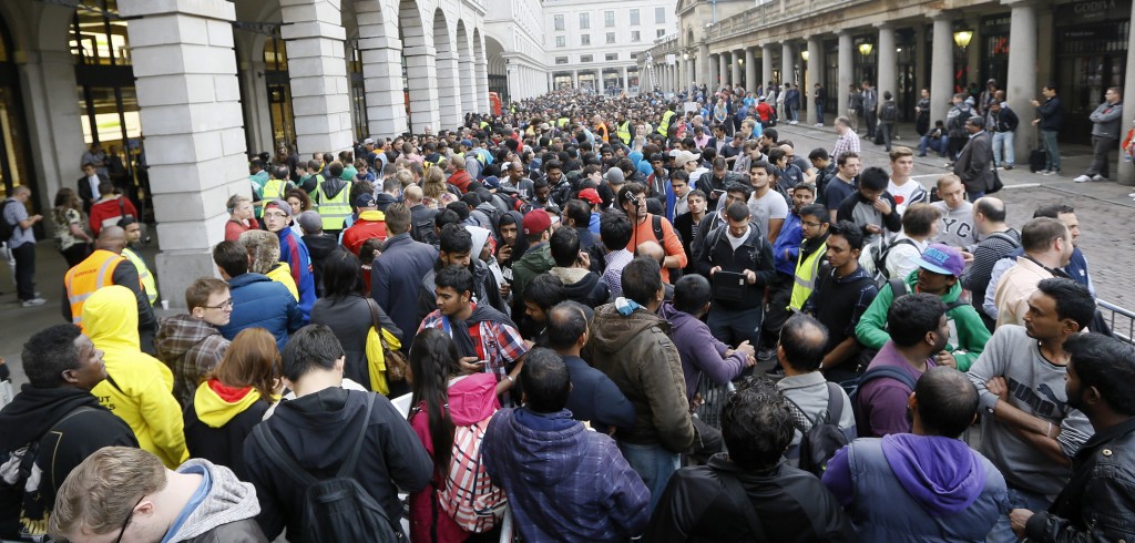 People queue outside the Apple shop in London, Friday, Sept. 19, 2014. The new Apple iPhone6 went on sale at the shop on Friday. (AP Photo/Kirsty Wigglesworth)