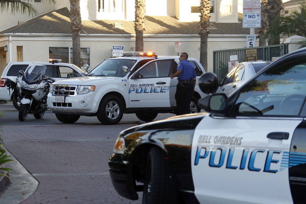 Police officers stand by the scene of a shooting in Bell Gardens, Calif., Tuesday, Sept. 30, 2014. Bell Gardens mayor Daniel Crespo was shot to death Tuesday during an argument with his wife, who was taken into custody, authorities said. (AP Photo/Nick Ut)