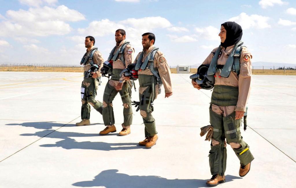 In this June 13, 2013 photo provided by the Emirates News Agency, WAM, Maj. Mariam al-Mansouri, the first Emirati female fighter jet pilot, right, walks with other pilots at an undisclosed location in United Arab Emirates. A senior United Arab Emirates diplomat says the Gulf federations first female air force pilot helped carry out airstrikes against Islamic State militants earlier this week. The Emirati embassy in Washington said on its official Twitter feed Thursday, Sept. 25, 2014 that Ambassador Yousef al-Otaiba confirmed the F-16 pilots role. Rumors had swirled on social media that Maj. Mariam al-Mansouri was involved in the strikes, but Emirati officials had not previously confirmed that was the case.(AP Photo/Emirates News Agency, WAM)