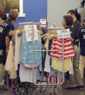 Law enforcement agents check a clothing store during a raid in the Los Angeles Fashion District Wednesday, Sept. 10, 2014. U.S. agents raided dozens of businesses in the fashion district of Los Angeles early Wednesday as part of an investigation into suspected money laundering done for Mexican drug cartels. (AP Photo/ Nick Ut )