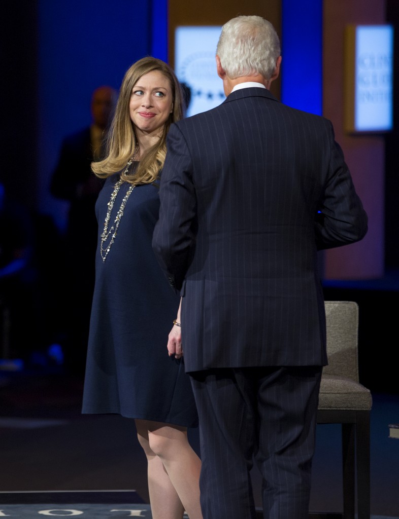 Chelsea Clinton glances at her father, former President Bill Clinton, during the closing session of the Clinton Global Initiative in New York Wednesday, Sept. 24, 2014. (AP Photo/Craig Ruttle)
