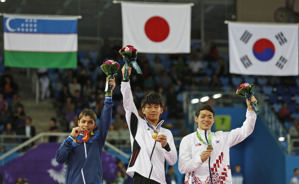 From left to right, silver medallist Uzbekistan's Abdulla Azimov, gold medallist Japan's Masayoshi Yamamoto and bronze medallist South Korea's Park Min-soo celebrate during the medal ceremony for the gymnastics men's pommel horse final at the 17th Asian Games in Incheon, South Korea, Wednesday, Sept. 24, 2014.  (AP Photo/Kin Cheung)