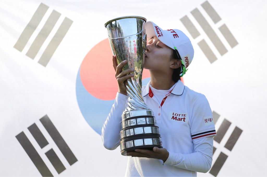 Kim Hyo-joo of South Korea kisses her trophy as she poses for photographers after winning the Evian Championship women's golf tournament in Evian, eastern France, Sunday, Sept. 14, 2014. (AP Photo/Laurent Cipriani)