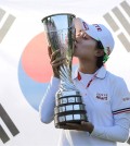 Kim Hyo-joo of South Korea kisses her trophy as she poses for photographers after winning the Evian Championship women's golf tournament in Evian, eastern France, Sunday, Sept. 14, 2014. (AP Photo/Laurent Cipriani)