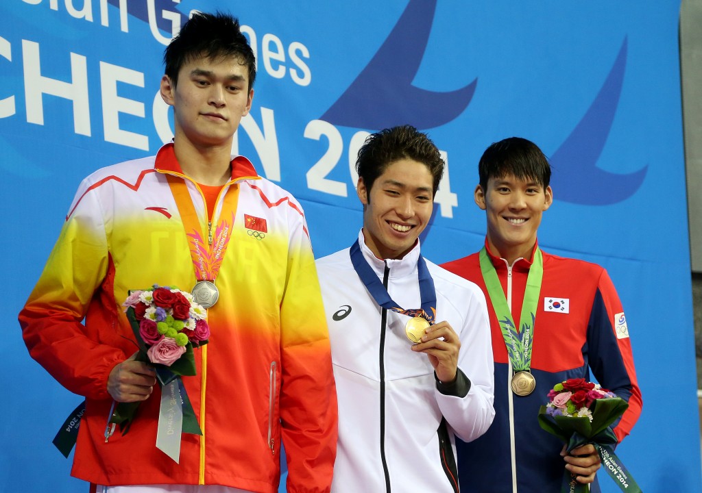 From left, silver medalist China's Sun Yang, gold Japan's Kosuke Hagino and bronze South Korea's Park Tae-hwan  pose for  photo on the podium after the men's 200-meter freestyle swimming final at the 17th Asian Games in Incheon, South Korea,  Sunday, Sept. 21, 2014.(AP Photo/Rob Griffith)