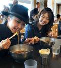 A customer at a Koreatown restaurant enjoys an ice-filled bowl of cold nengmyun. (Park Sang-hyuk/The Korea Times)