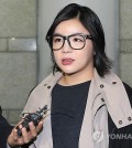 Amy talks to a reporter on her way to the courtroom. (Yonhap)