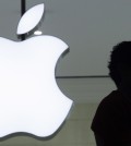 FILE - In a Wednesday, Dec. 7, 2011, file photo, a person stands near the Apple logo at the company's store in Grand Central Terminal, in New York. There's a shadowy global industry devoted to unlocking phones and extracting their information. For digital forensics companies, success can mean big bucks in the form of government contracts. And the notoriety that could come with cracking an iPhone used by a purported terrorist could rocket them to cyber stardom. (AP Photo/Mark Lennihan, File)