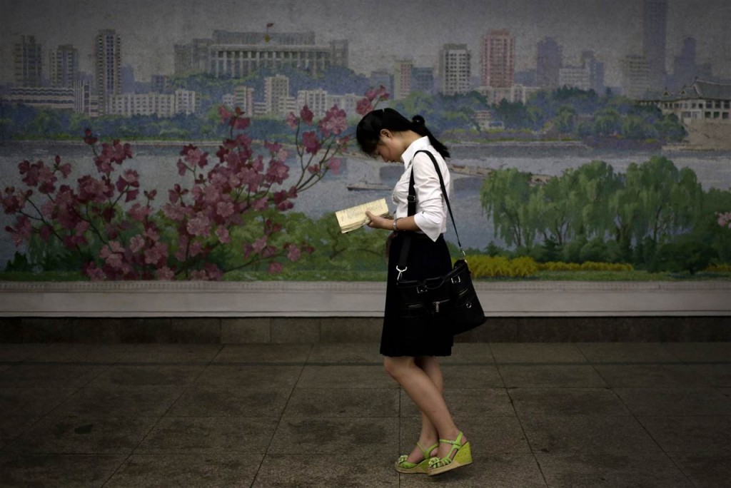 In this Sept. 1, 2014 photo, a North Korean woman waits for a train in an underground subway station in Pyongyang, North Korea.  In Pyongyang, where the standard of living is relatively high, clothes and styles have been changing in recent years - slowly and in a limited way, but more than many outsiders might think. (AP Photo/Wong Maye-E)