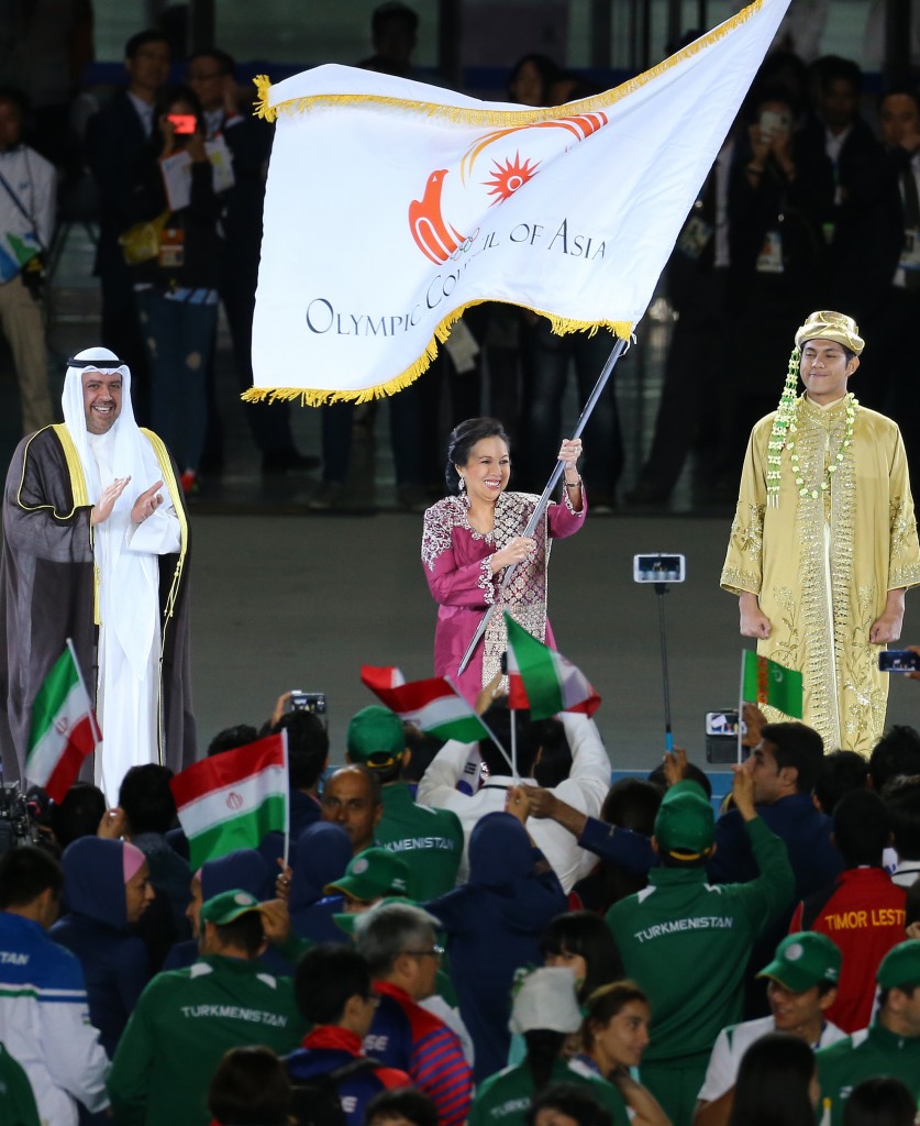 Rita Subowo, middle, President of National Olympics Committee of Indonesia, holds the Olympic Council of Asia flag during the closing ceremony for the 17th Asian Games in Incheon, South Korea, Saturday, Oct. 4, 2014. (Yonhap)