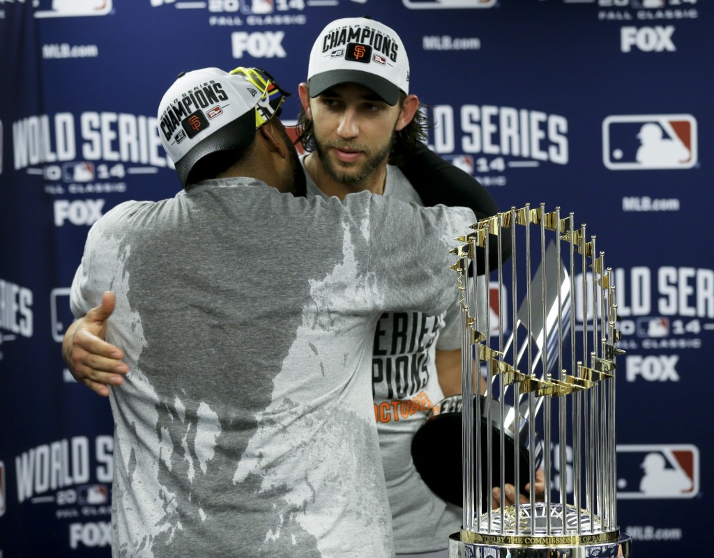 His teammates couldn't thank him enough. San Francisco Giants starting pitcher Madison Bumgarner, right, gets a hug from Pablo Sandoval as Bumgarner won the MVP trophy after their 3-2 win against the Kansas City Royals in Game 7 of baseball's World Series Wednesday, Oct. 29, 2014, in Kansas City, Mo. (AP Photo/Charlie Neibergall)