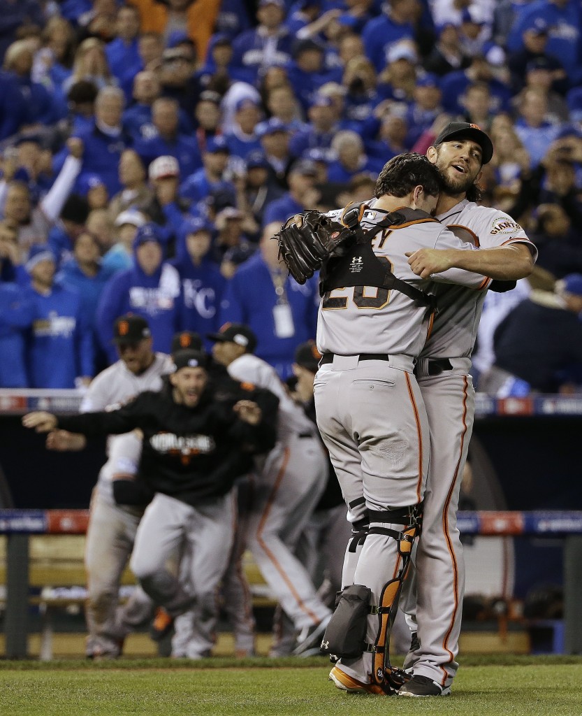 San Francisco Giants' Madison Bumgarner and catcher Buster Posey celebrate after Game 7 of baseball's World Series against the Kansas City Royals Wednesday, Oct. 29, 2014, in Kansas City, Mo. The Giants won 3-2 to win the series. (AP Photo/David J. Phillip)