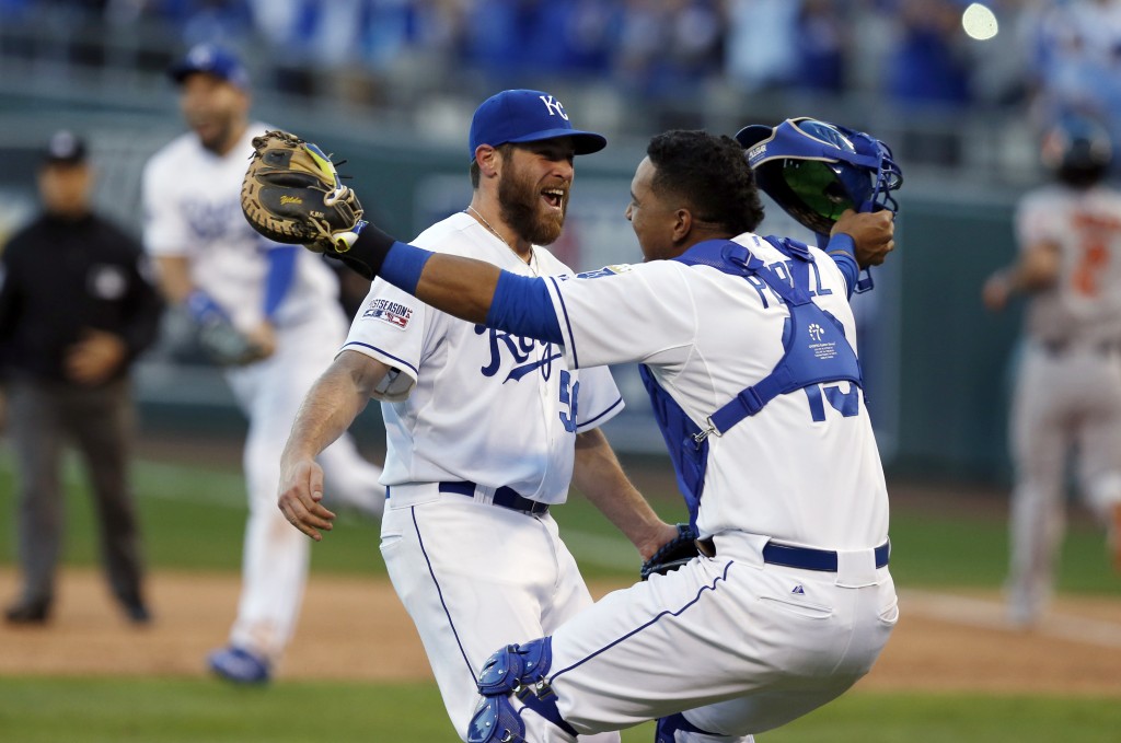 Kansas City Royals relief pitcher Greg Holland and catcher Salvador Perez celebrate after defeating against the Baltimore Orioles 2-1 in Game 4 of the American League baseball championship series Wednesday, Oct. 15, 2014, in Kansas City, Mo. The Royals advance to the World Series. (AP Photo/Orlin Wagner)