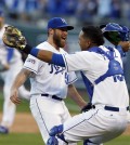 Kansas City Royals relief pitcher Greg Holland and catcher Salvador Perez celebrate after defeating against the Baltimore Orioles 2-1 in Game 4 of the American League baseball championship series Wednesday, Oct. 15, 2014, in Kansas City, Mo. The Royals advance to the World Series. (AP Photo/Orlin Wagner)