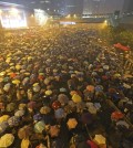 Pro-democracy protesters hold umbrellas under heavy rain in a main street near the government headquarters in Hong Kong, late Tuesday, Sept. 30, 2014. Pro-democracy protesters demanded that Hong Kong's top leader meet with them on Tuesday and threatened wider actions if he did not, after he said China would not budge in its decision to limit voting reforms in the Asian financial hub. (AP Photo)