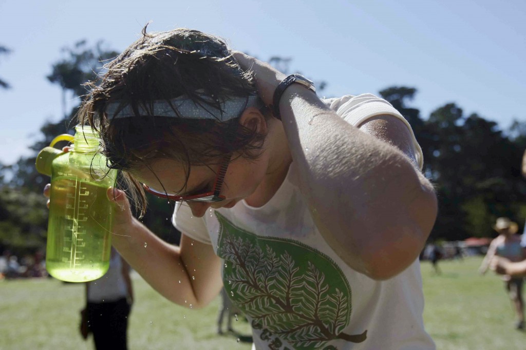 Karen Eisenhauer, of Claremont, Calif., cools off during the second day of the Hardly Strictly Bluegrass Festival in San Francisco's Golden Gate Park, Saturday, Oct. 4, 2014. As high temperatures were ranging from the low 100s in Southern California to the 90s in the normally more temperate San Francisco Bay Area on Friday, National Weather Service forecasters warned it was just a warm-up for what lies ahead this weekend. (AP Photo/San Francisco Chronicle, Jessica Christian)  