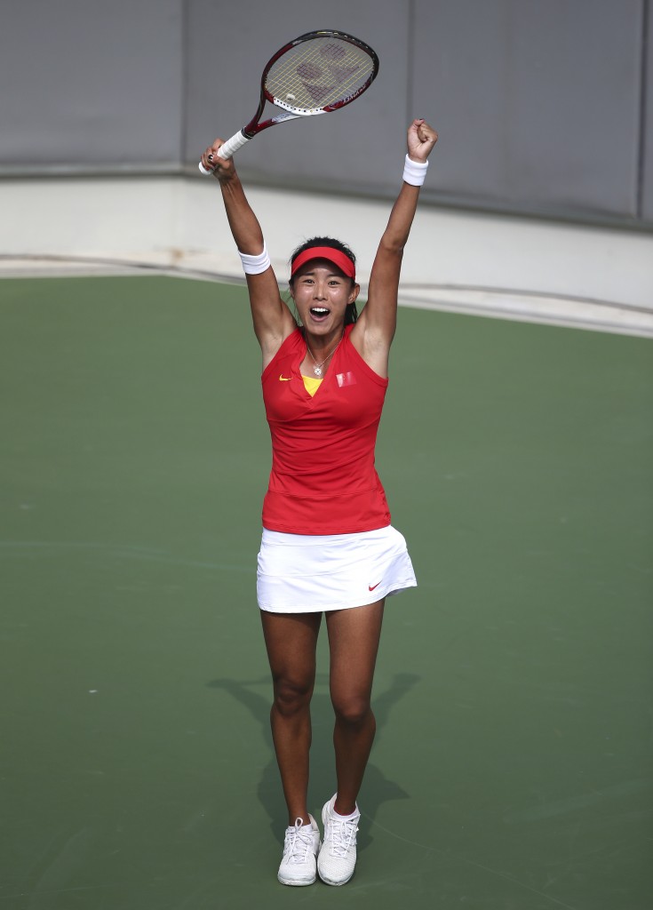 China's  Wang Qiang raises her arms up hi as she celebrates winning her women's tennis final against Thailand's Luksika Kumkhum at the 17th Asian Games in Incheon, South Korea,  Tuesday, Sept. 30, 2014.(AP Photo/Rob Griffith)