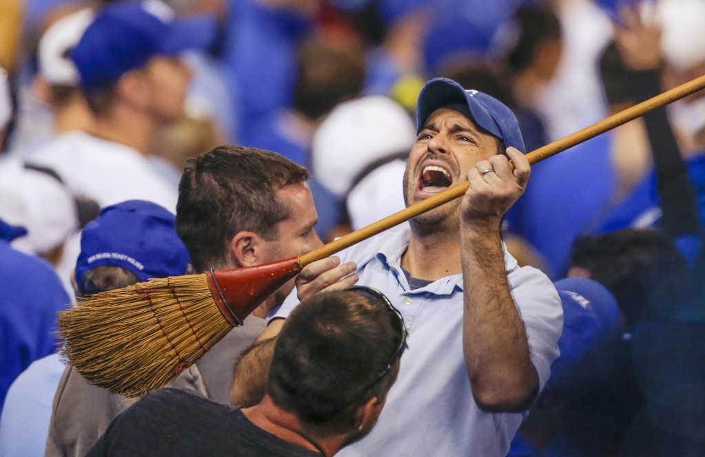 A Kansas City Royals fan celebrates with a broom during the sixth inning of Game 3 of baseball's AL Division Series against the Los Angeles Angels in Kansas City, Mo., Sunday, Oct. 5, 2014. (AP Photo/Orlin Wagner)