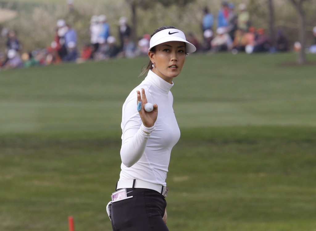 Michelle Wie reacts after sinking a birdie putt on the 18th hole during the final round of the KEB Hana Bank Championship golf tournament at Sky72 Golf Club in Incheon, South Korea, Sunday, Oct. 19, 2014.(AP Photo/Ahn Young-joon)