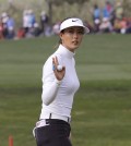 Michelle Wie reacts after sinking a birdie putt on the 18th hole during the final round of the KEB Hana Bank Championship golf tournament at Sky72 Golf Club in Incheon, South Korea, Sunday, Oct. 19, 2014.(AP Photo/Ahn Young-joon)