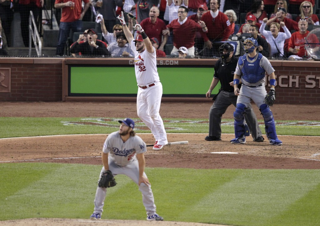 St. Louis Cardinals first baseman Matt Adams (32) celebrates as Los Angeles Dodgers starting pitcher Clayton Kershaw, front, catch A.J. Ellis and umpire Eric Cooper watch his, three-run home run in the seventh inning of Game 4 of baseball's NL Division Series Tuesday, Oct. 7, 2014, in St. Louis. (AP Photo/Tom Gannam)