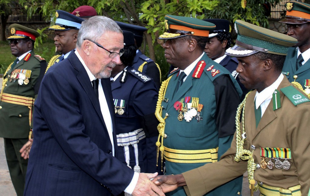 Zambia's vice president Guy Scott greets defense and security chiefs shortly after taking over as acting president, following the death in London on late Tuesday of President Michael Sata, Lusaka, Wednesday, Oct. 29, 2014. Scott, a white Zambian of Scottish descent, became the country's acting president on Wednesday, making him the first white leader of a sub-Saharan African nation since F.W. de Klerk, the apartheid-era head of South Africa who was voted out of power in 1994. (AP Photo)