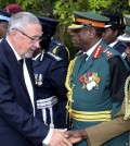 Zambia's vice president Guy Scott greets defense and security chiefs shortly after taking over as acting president, following the death in London on late Tuesday of President Michael Sata, Lusaka, Wednesday, Oct. 29, 2014. Scott, a white Zambian of Scottish descent, became the country's acting president on Wednesday, making him the first white leader of a sub-Saharan African nation since F.W. de Klerk, the apartheid-era head of South Africa who was voted out of power in 1994. (AP Photo)