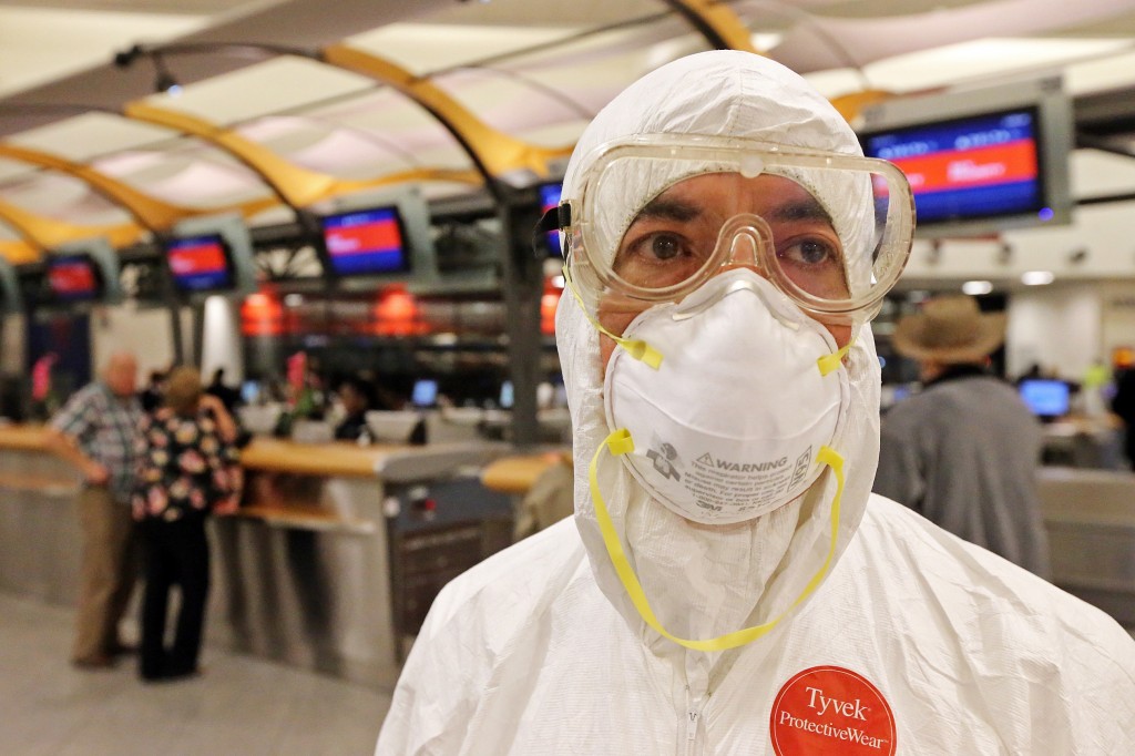 Two days after a man in Texas was diagnosed with Ebola, Dr. Gil Mobley, a Missouri doctor, checked in and boarded a plane dressed in full protection gear Thursday morning, Oct. 2, 2014, at Hartsfield-Jackson Atlanta International Airport. He was protesting what he called mismanagement of the crisis by the federal Centers for Disease Control and Prevention. (AP Photo/Atlanta Journal-Constitution, John Spink) 