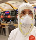 Two days after a man in Texas was diagnosed with Ebola, Dr. Gil Mobley, a Missouri doctor, checked in and boarded a plane dressed in full protection gear Thursday morning, Oct. 2, 2014, at Hartsfield-Jackson Atlanta International Airport. He was protesting what he called mismanagement of the crisis by the federal Centers for Disease Control and Prevention. (AP Photo/Atlanta Journal-Constitution, John Spink)