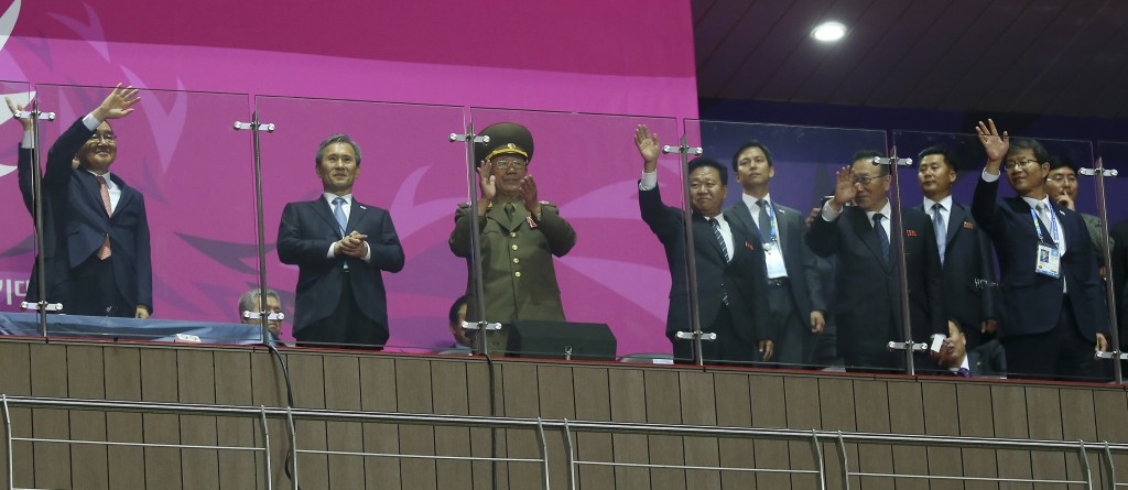North Korea’s National Defense Commission Vice Chairman Hwang Pyong So, third left, and North Korea’s ruling Workers Party secretaries, Choe Ryong Hae, third right, and Kim Yang Gon, second right, are wave with South Korean Prime Minister Chung Hong-won, left, South Korean President Park Geun-hye's National Security Adviser Kim Kwan-jin, second left, and South Korean Unification Minister Ryoo Kihl-jae during the closing ceremony for the 17th Asian Games in Incheon, South Korea, Saturday, Oct. 4, 2014. Hwang, North Korea's presumptive No. 2, and other members of Pyongyang's inner circle met with South Korean officials Saturday in the rivals' highest level face-to-face talks in five years, a possible indication that both sides are interested in pursuing better ties after months of animosity. (AP Photo/Yonhap, Han Jong-chan)  