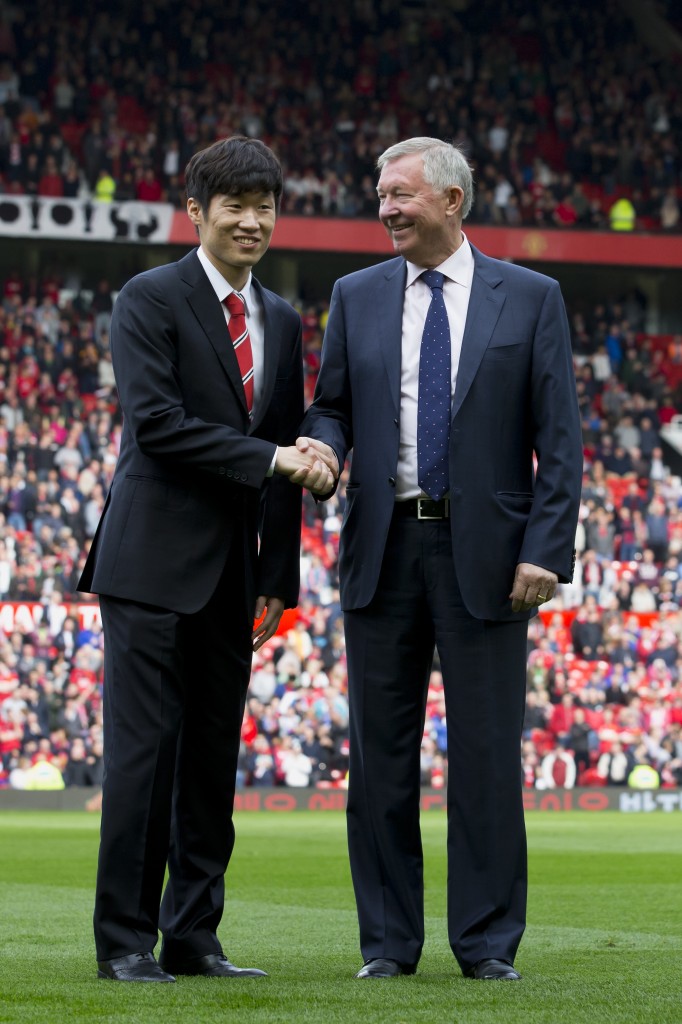 Manchester United former player Park Ji-sung, left, shakes hands with  former manager Alex Ferguson as the former is introduced as a new ambassador for the club before the team's English Premier League soccer match against  Everton at Old Trafford Stadium, Manchester, England, Sunday Oct. 5, 2014. (AP Photo/Jon Super)