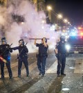 San Francisco police officers work to break up a large crowd who were celebrating after the San Francisco Giants won the World Series baseball game against the Kansas City Royals on Wednesday, Oct. 29, 2014, in San Francisco.  There were several reports of fires being set and violence breaking out after the Giants win. (AP Photo/Noah Berger)