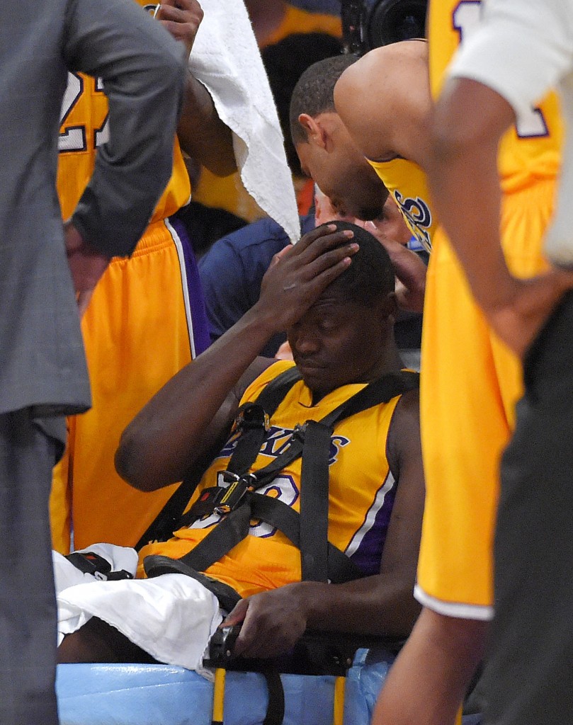 Los Angeles Lakers forward Julius Randle, right, sits on on a stretcher after Randle injured himself on a play during the second half of an NBA basketball game, Tuesday, Oct. 28, 2014, in Los Angeles. (AP Photo/Mark J. Terrill)