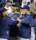 Los Angeles Dodgers' Justin Turner, from left, pitcher Clayton Kershaw, pitcher Hyun-Jin Ryu, of South Korea, and Scott Van Slyke joke around in the dugout before a baseball game against the San Francisco Giants Monday, Sept. 22, 2014, in Los Angeles. (AP Photo/Jae C. Hong)