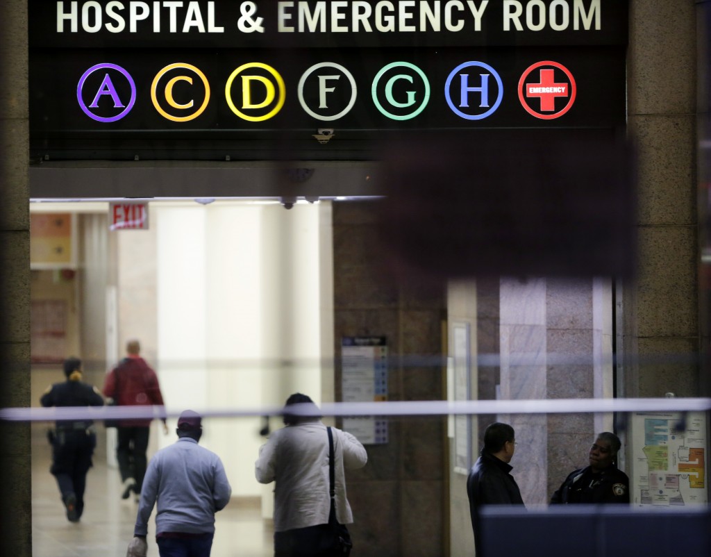 People walk through the lobby of Bellevue Hospital, Friday, Oct. 24, 2014, in New York. Dr. Craig Spencer, a resident of New York City and a member of Doctors Without Borders, was admitted to Bellevue on Thursday and has been diagnosed with Ebola. (AP Photo/Mark Lennihan)