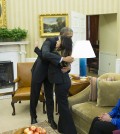 President Barack Obama hugs Ebola survivor Nina Pham in the Oval Office of the White House in Washington, Friday, Oct. 24, 2014. Pham, the first nurse diagnosed with Ebola after treating an infected man at a Dallas hospital is free of the virus. The 26-year-old Pham arrived last week at the NIH Clinical Center. She had been flown there from Texas Health Presbyterian Hospital Dallas. Pham's mother Diana, center, and sister Cathy Pham watch.  (AP Photo/Evan Vucci)